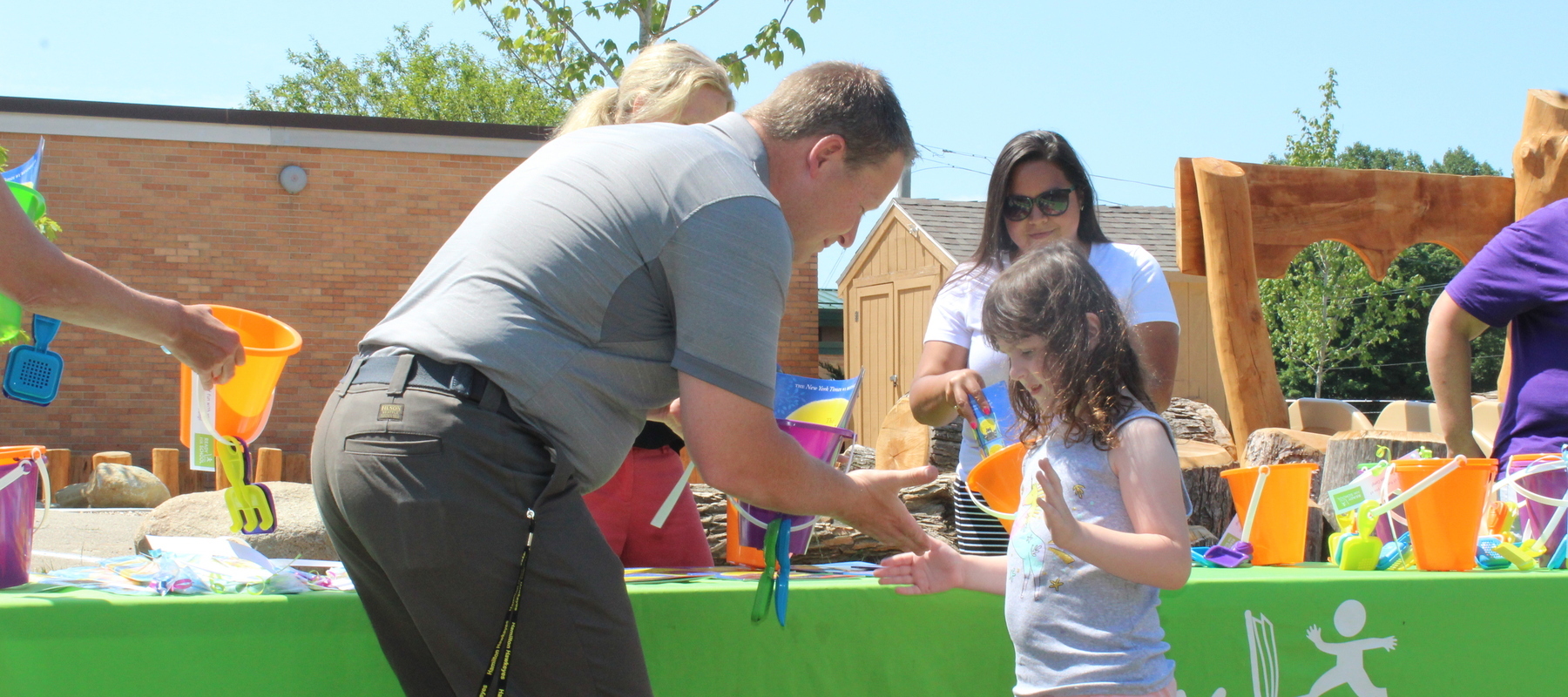 A Kindergarten Readiness Camp graduate shakes the hand of superintendent, Bradford Lusk.