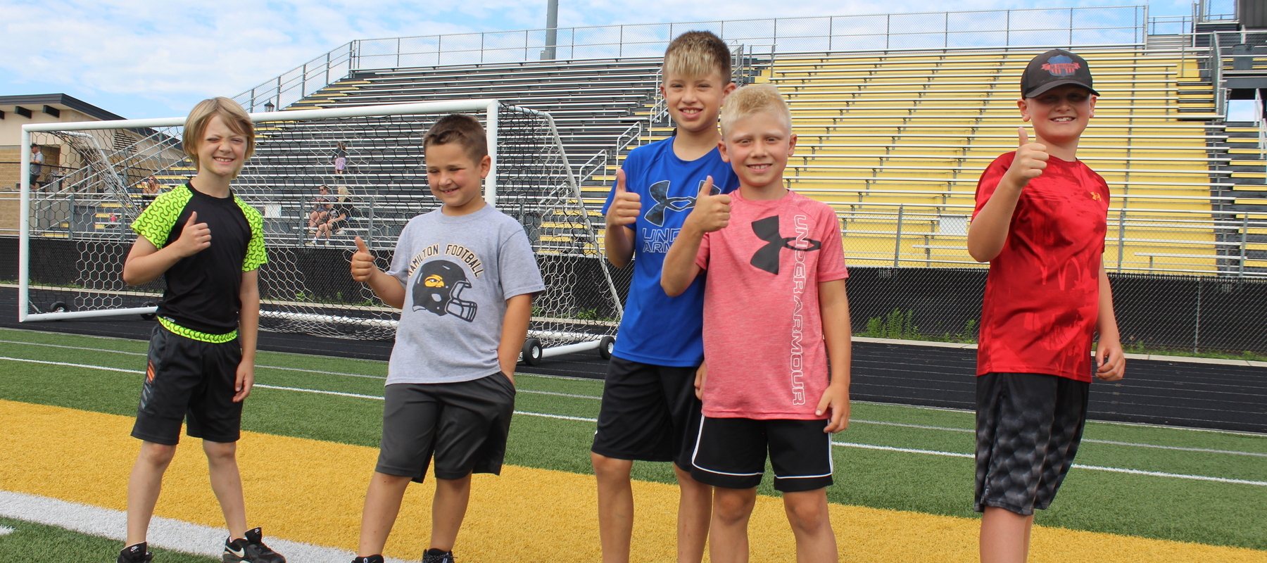 Young players smile at the Hamilton football program's 'Kids Day' camp