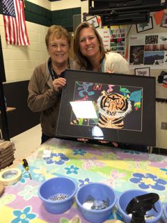 Grandma and Mom frame their student's  piece for the 2014 Art Show