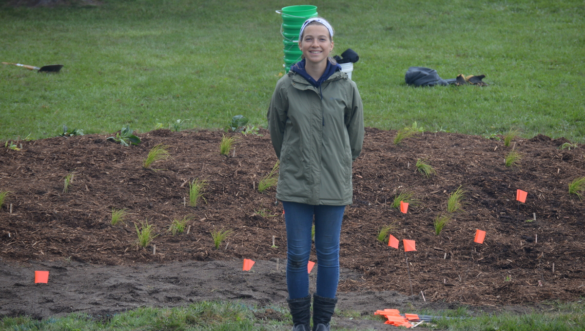 Alyssa Franck in front of the Blue Star Elementary rain garden. Photo via Kristie Phillips.