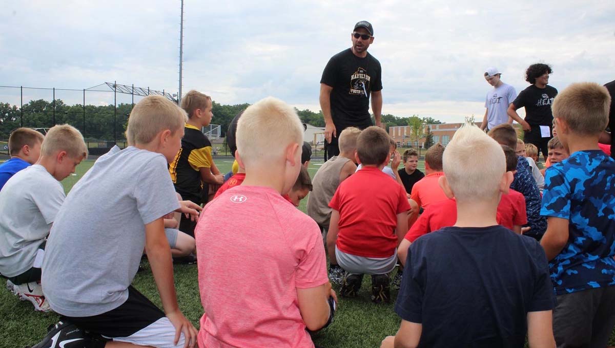 Varsity head coach Phil Koops addresses the kids at the start of camp.