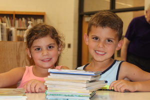 Children pose with their books at Hamilton Elementary's summer reading library.
