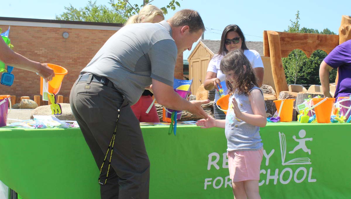 Hamilton Community Schools superintendent, Dr. Brad Lusk shakes the hand of a Readiness Camp graduate.