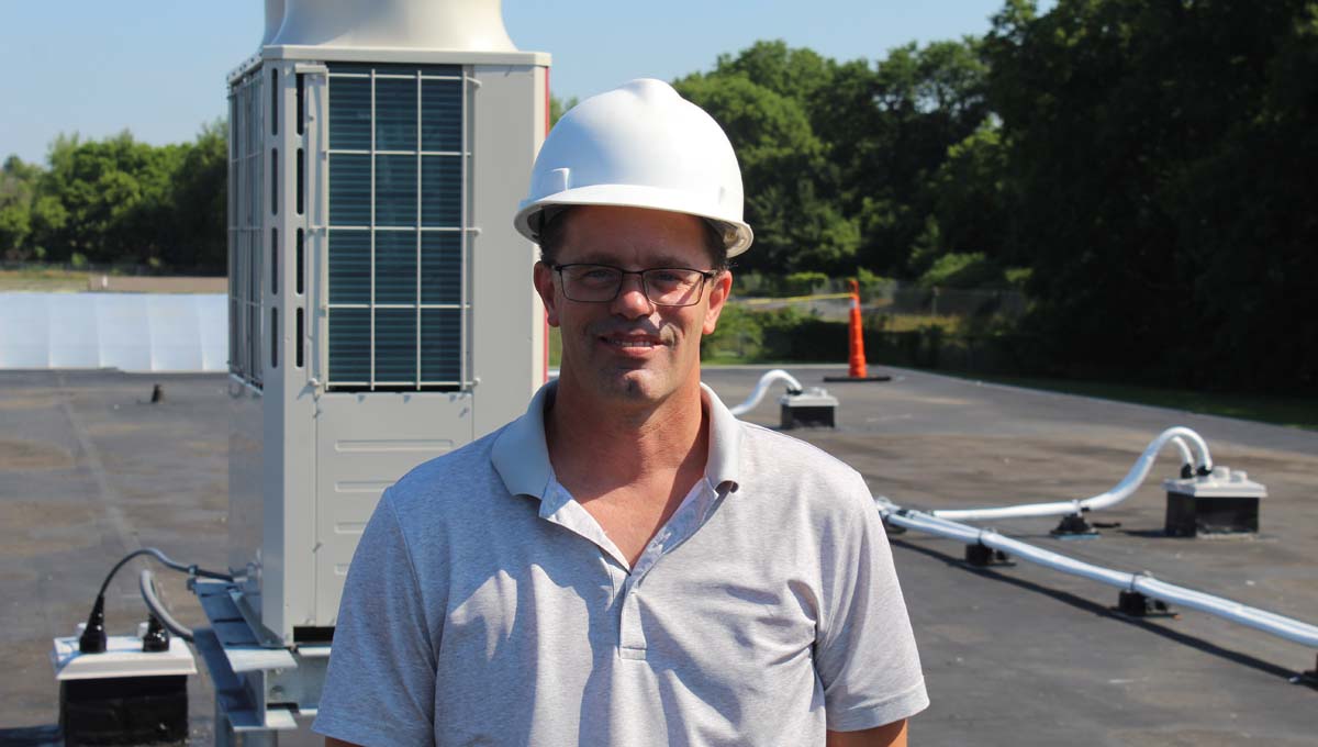 Maintenance and grounds supervisor Keith Folkert smiles as he looks over the climate control changes.